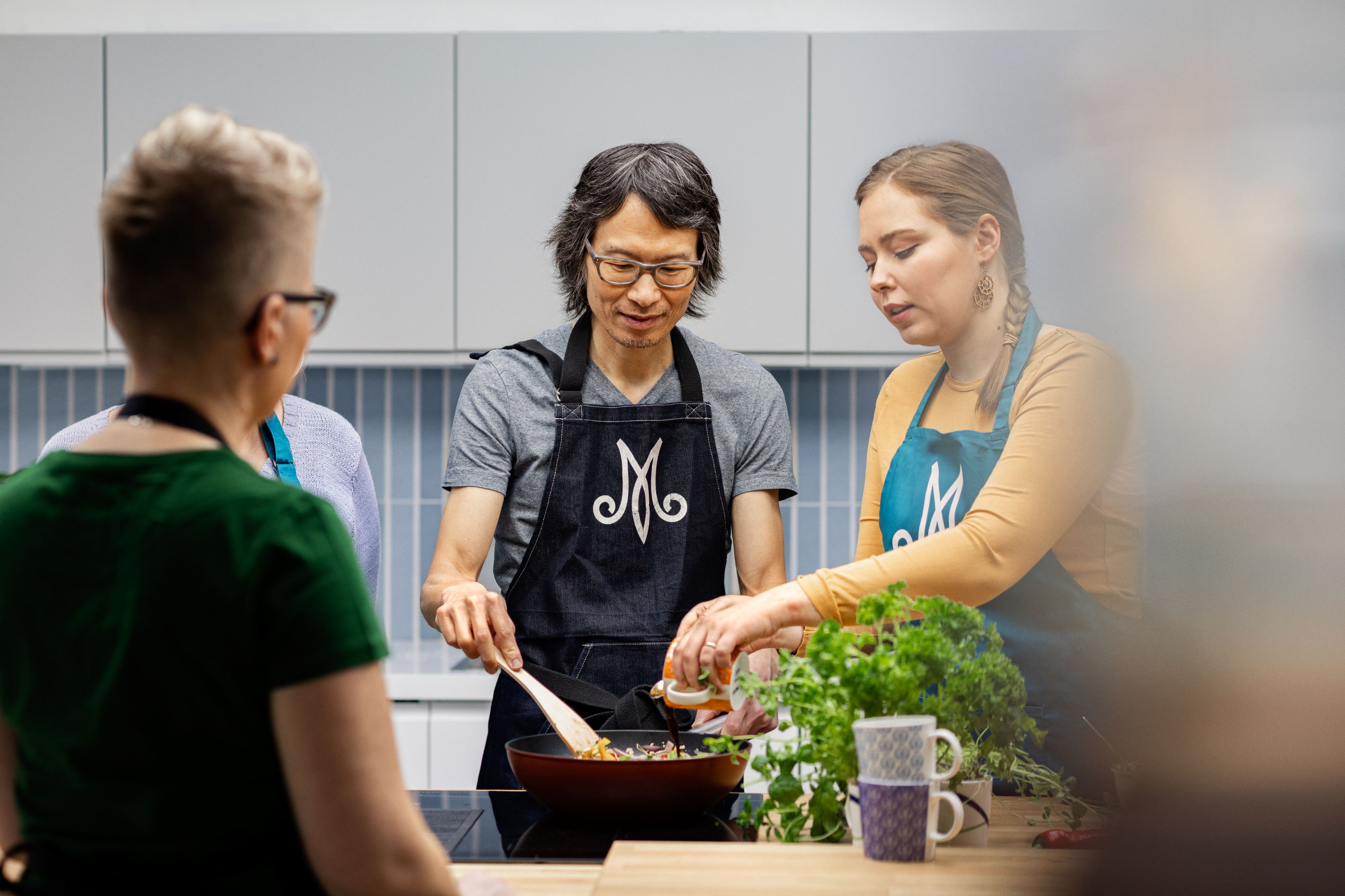 People cooking together in kitchen, Lapin Martat, Rovaniemi, Lapland, Finland