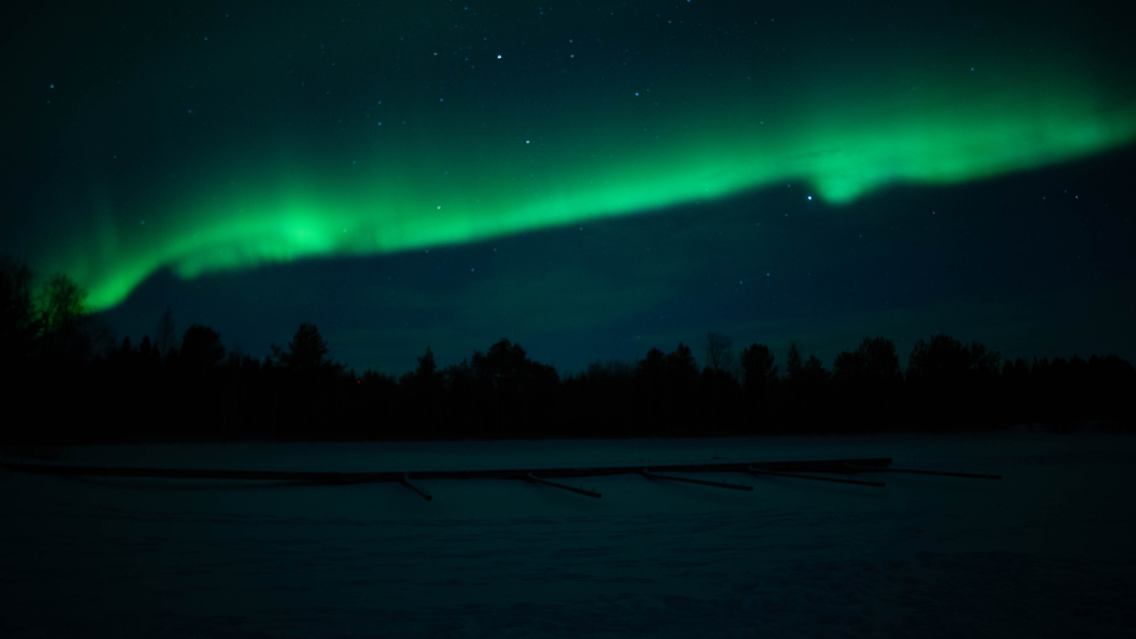 Green northern lights in sky in Rovaniemi, Lapland, Finland