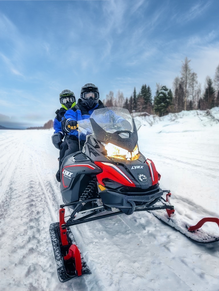 Two persons on a snowmobile in Rovaniemi, Lapland, Finland, PolarMax Adventures