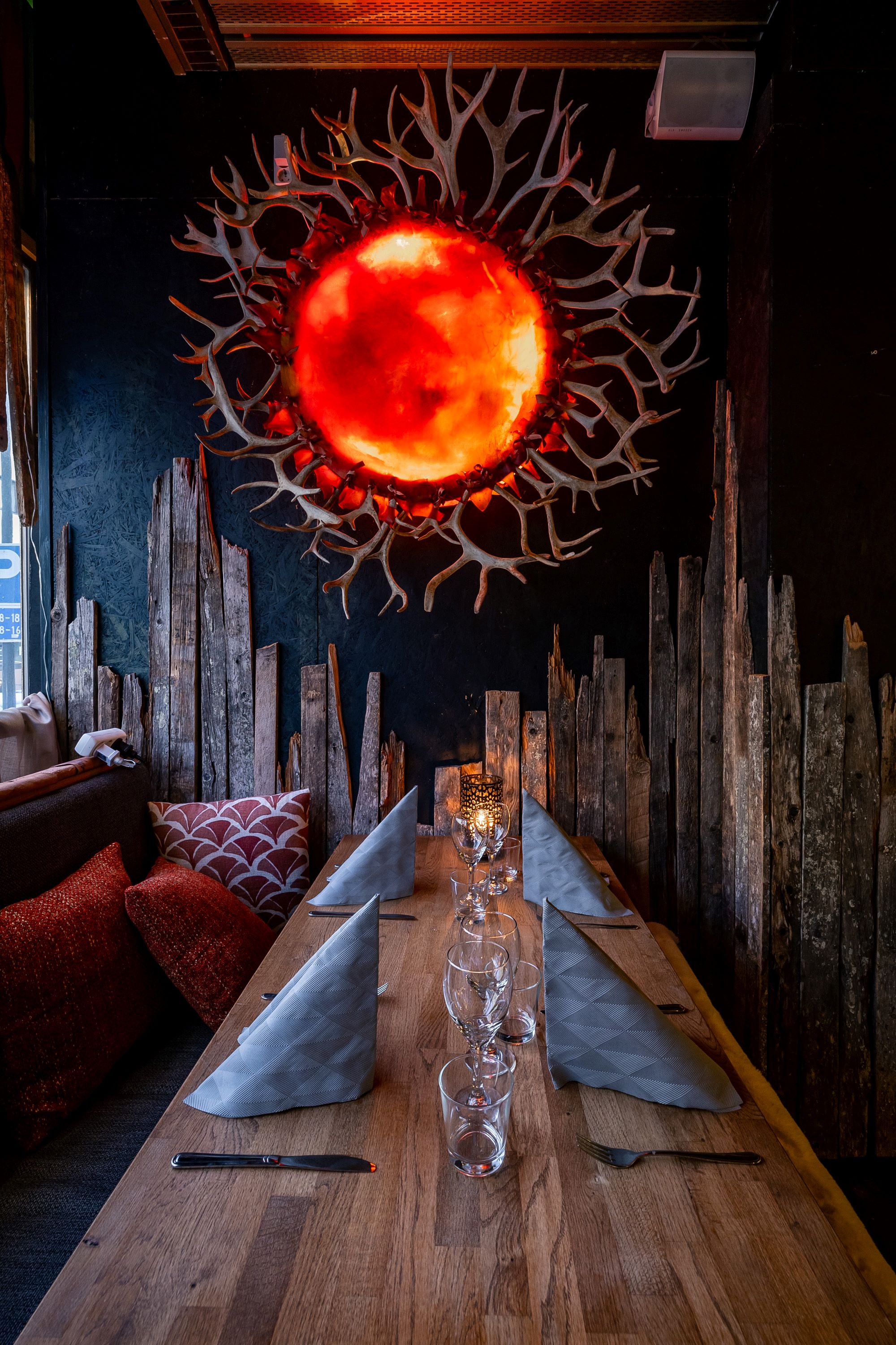 restaurant table with art work of sun and reindeer antlers as sun rays, Restaurant Nest, Rovaniemi, Lapland, Finland