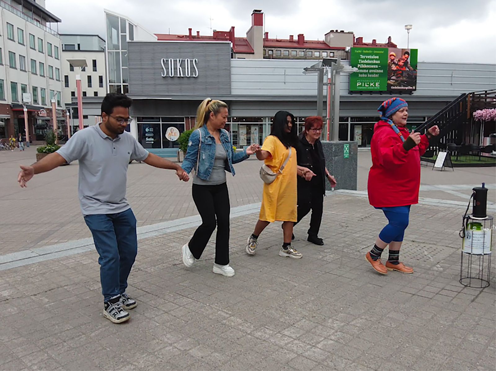 a group of people dancing at Lordi's Square with Rovaniemi Wellness Tours