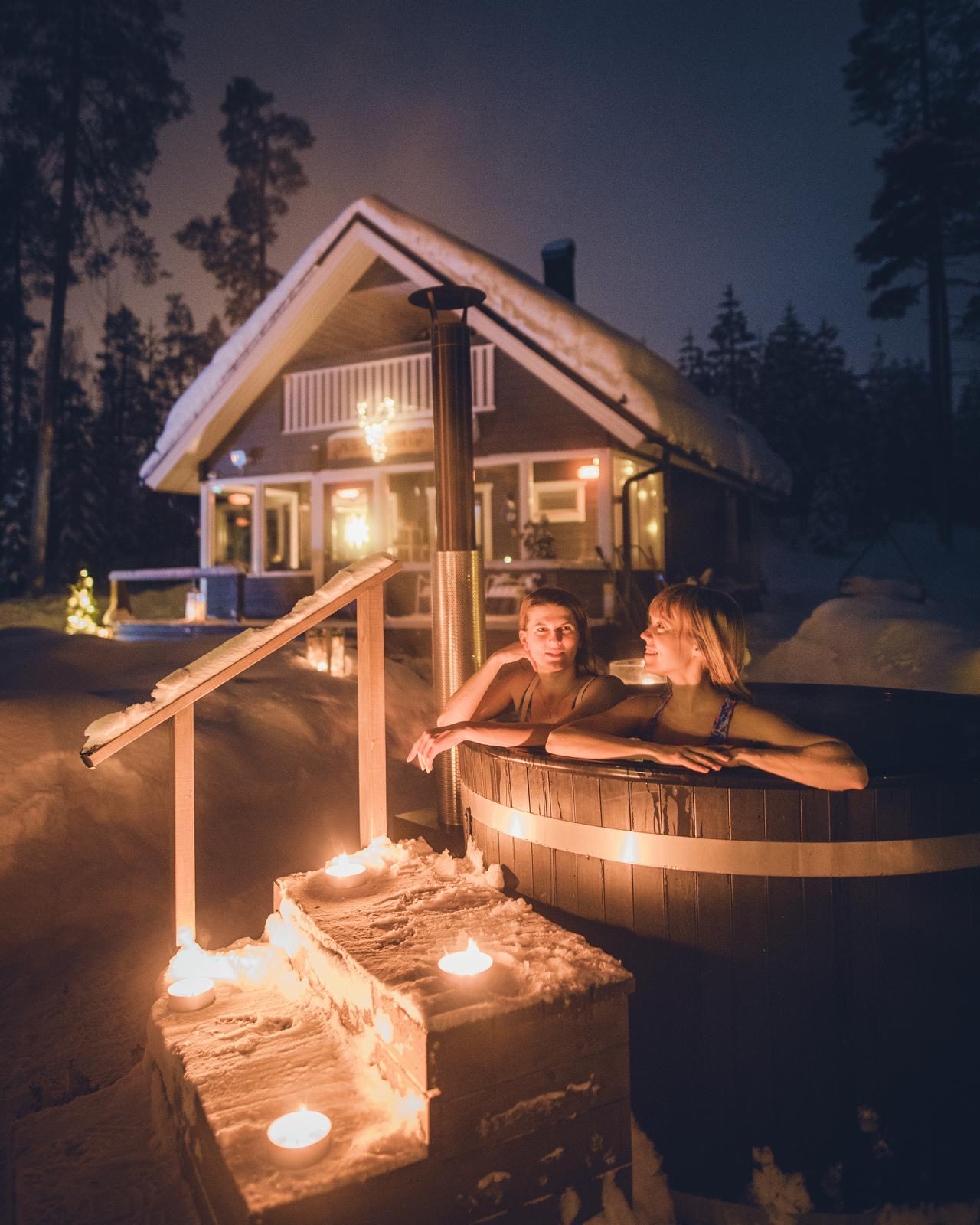 two people in a outside hot tub in wintertime, Lapland Royal Adventures, Rovaniemi, Lapland, Finland