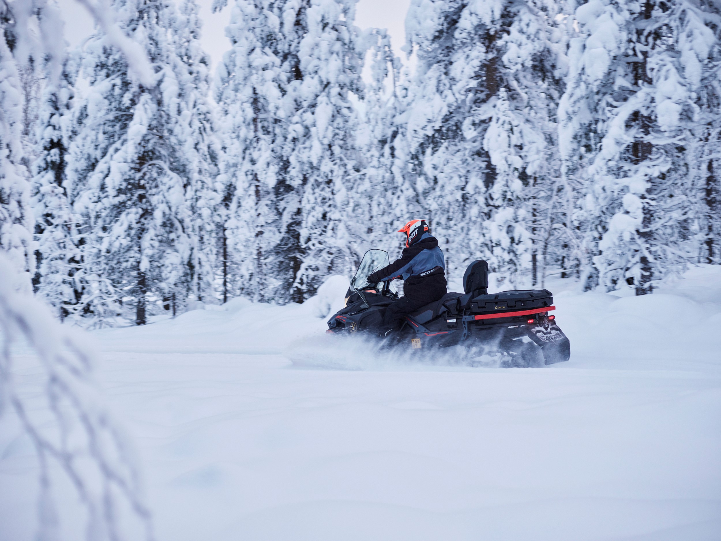 Snowmobiling in the snowy forest in Rovaniemi, Lapland, Finland, Arctra DMC