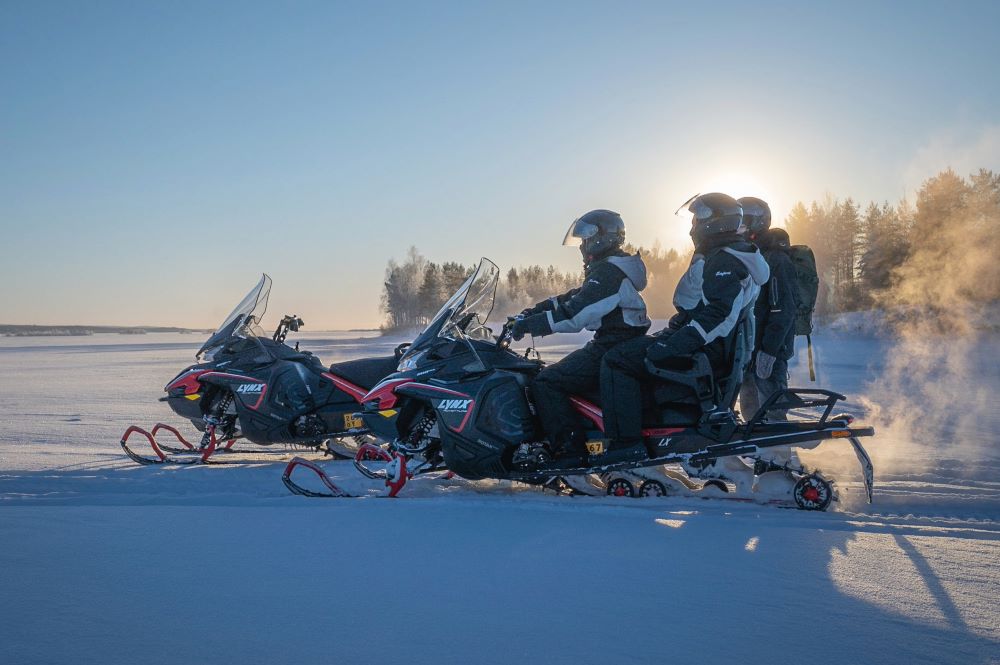 people snowmobiling in winter